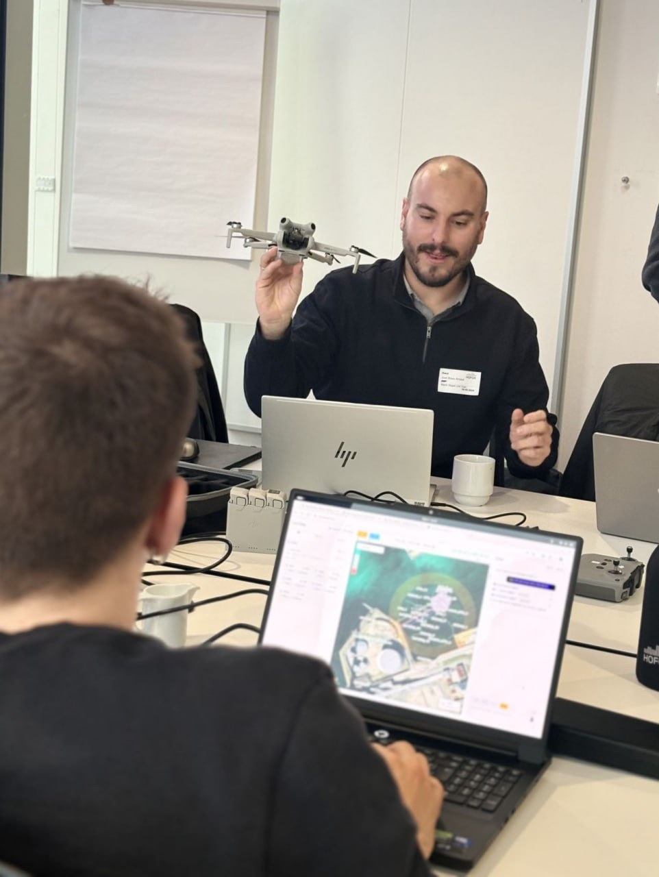 Demonstrating drone hardware and real-time mission telemetry UI on laptop